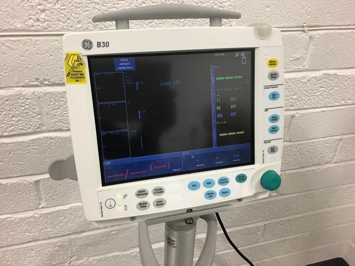 GE patient monitor on roll stand B30